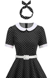 Rundhalsad prickig svart A-linje 1950-talsklänning