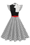 Höghalsad prickig svart En linje 1950-talsklänning med rosett
